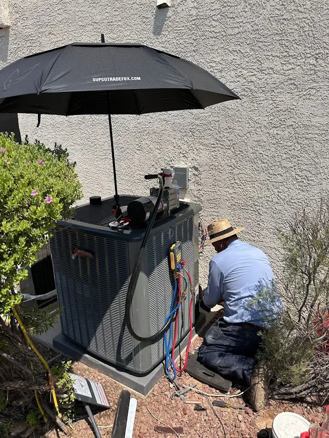HVAC technician performing outdoor AC maintenance in Florida City