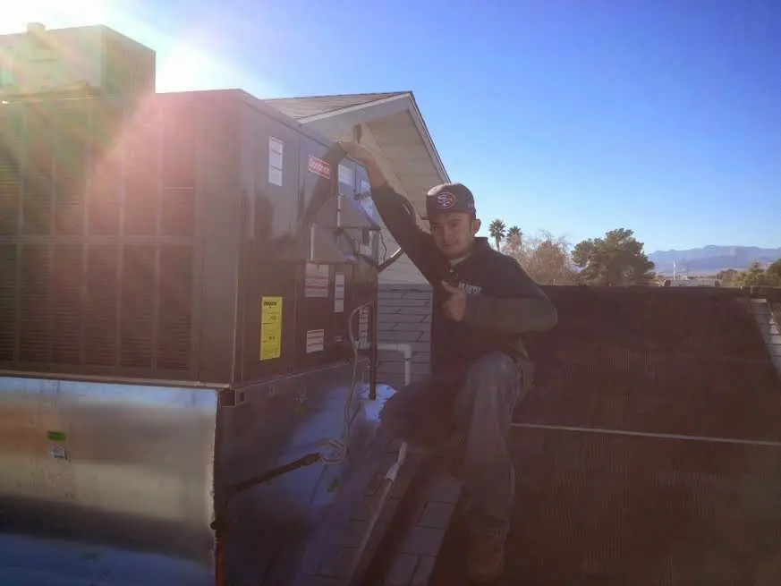 HVAC technician performing AC Tune-Up on a rooftop unit in Florida City